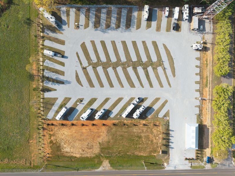 Top-down aerial of an RV park’s gravel loop and campsites