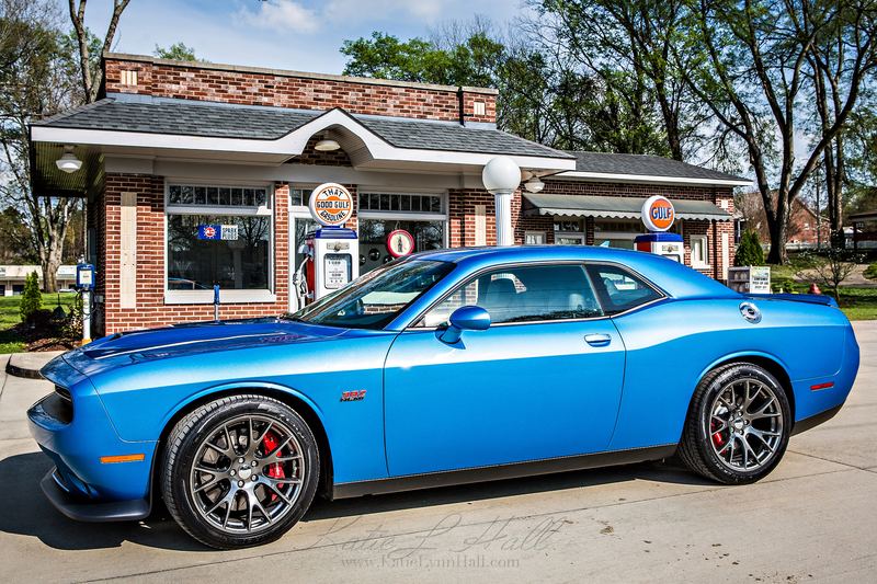 Blue Dodge Challenger in front of a vintage service station
