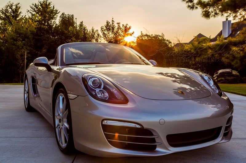 Silver Porsche Boxster at sunset