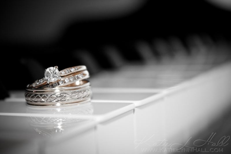 Wedding rings on piano keys, black and white