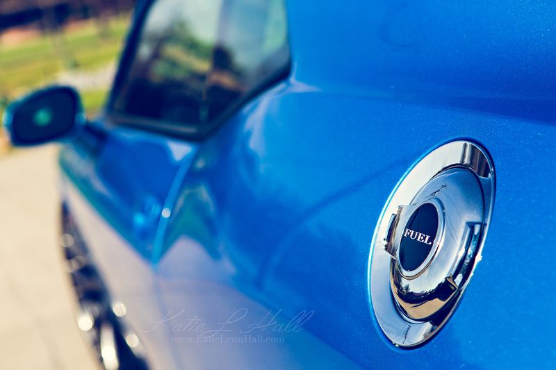 Close-up of a blue car’s chrome fuel cap