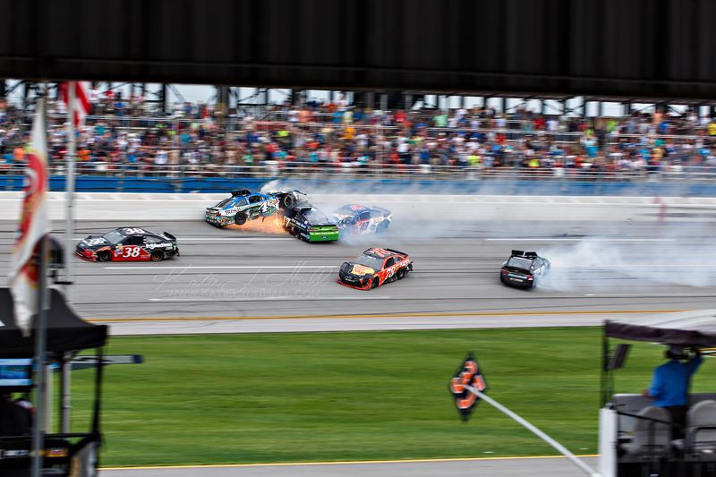 Multi-car crash on a speedway seen from the infield
