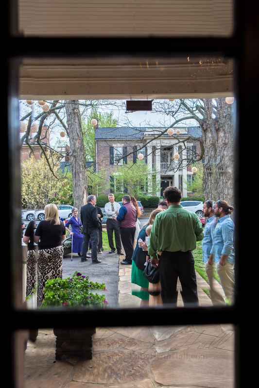 Wedding guests seen through a window frame