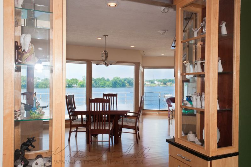 Lake-view dining room seen through built-in display cabinets